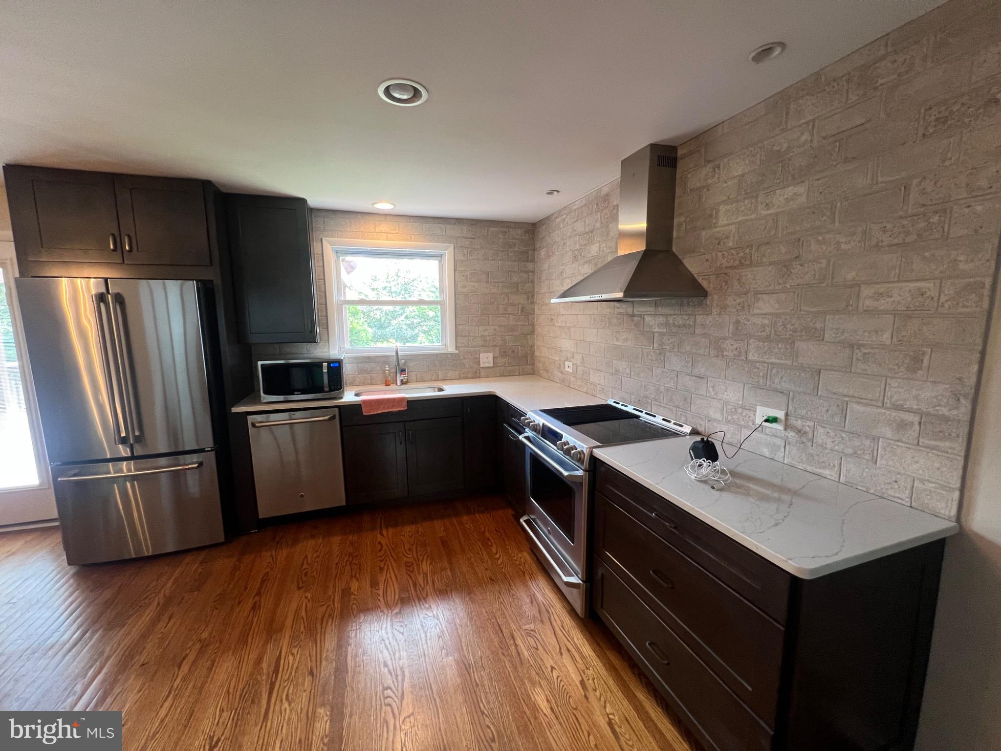 20 Fairview Road Swarthmore, PA 19081 - Photo 5 of 24 a kitchen with stainless steel appliances granite countertop a sink stove and refrigerator