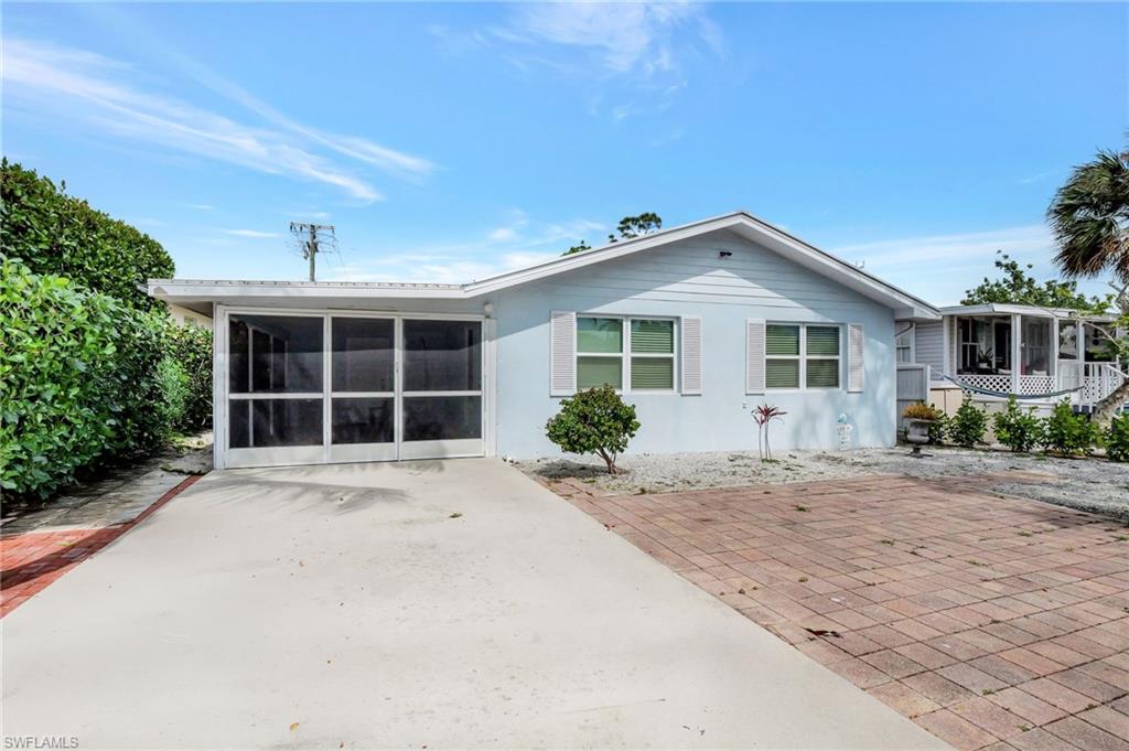 1009 Ridge Street Naples, FL 34103 - Photo 1 of 30 a front view of a house with a yard and garage
