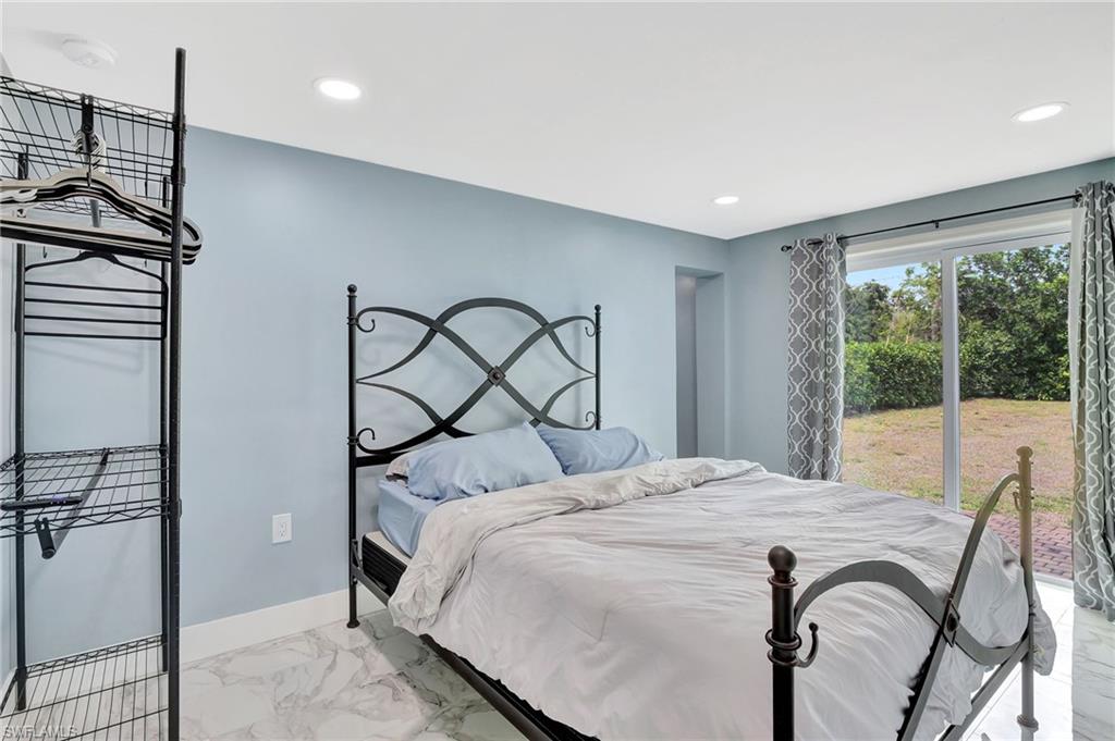 1009 Ridge Street Naples, FL 34103 - Photo 16 of 30 a bedroom with a bed and a window