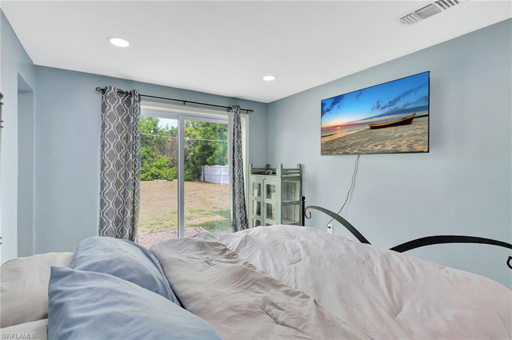 1009 Ridge Street Naples, FL 34103 - Photo 17 of 30 a bedroom with a bed and a painting on the wall