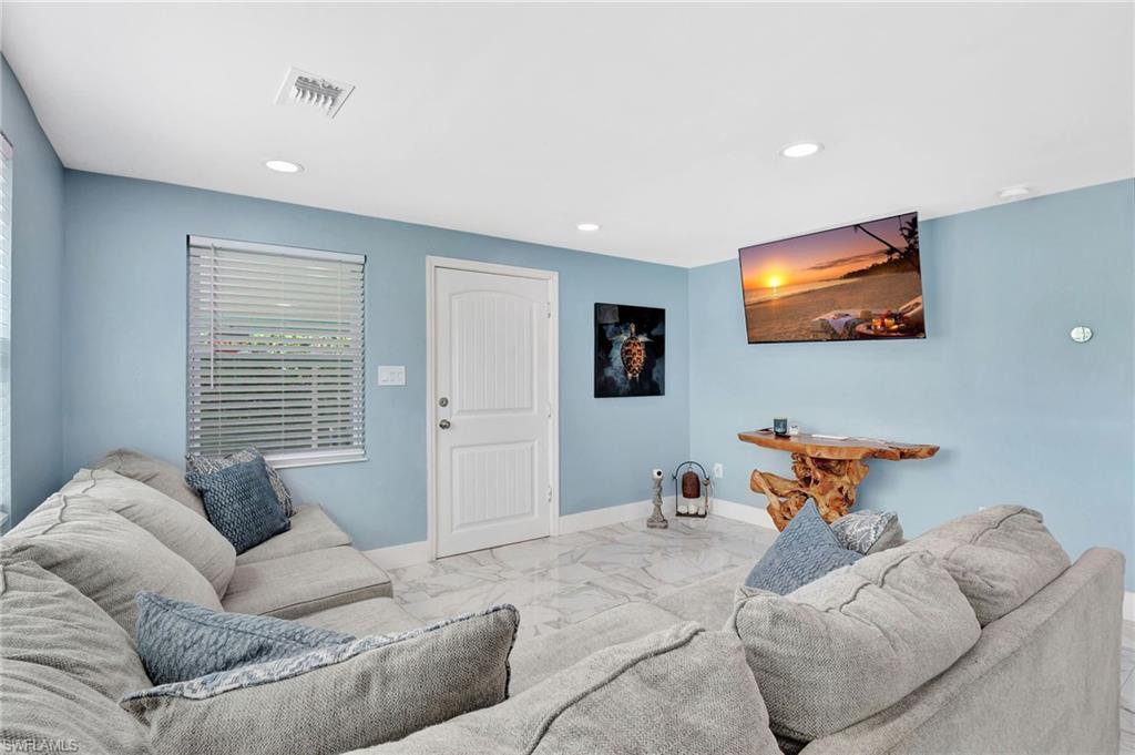 1009 Ridge Street Naples, FL 34103 - Photo 28 of 30 a living room with furniture and a flat screen tv