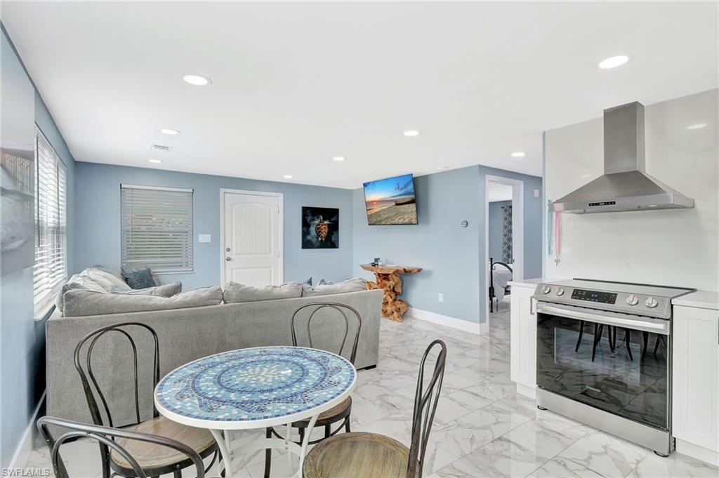 1009 Ridge Street Naples, FL 34103 - Photo 7 of 30 a living room with furniture a table and a fireplace