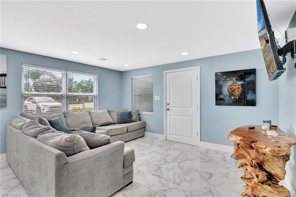 1009 Ridge Street Naples, FL 34103 - Photo 10 of 30 a living room with furniture and a flat screen tv