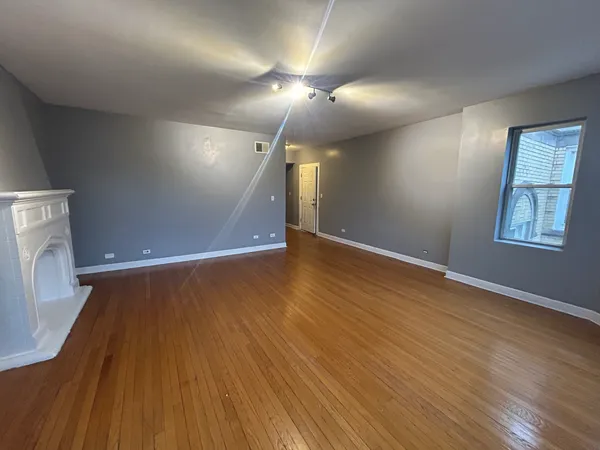 an empty room with wooden floor