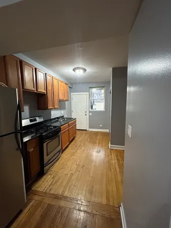 a kitchen with granite countertop a stove and a refrigerator
