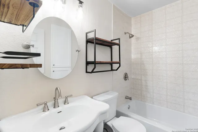 a bathroom with a sink toilet and shower