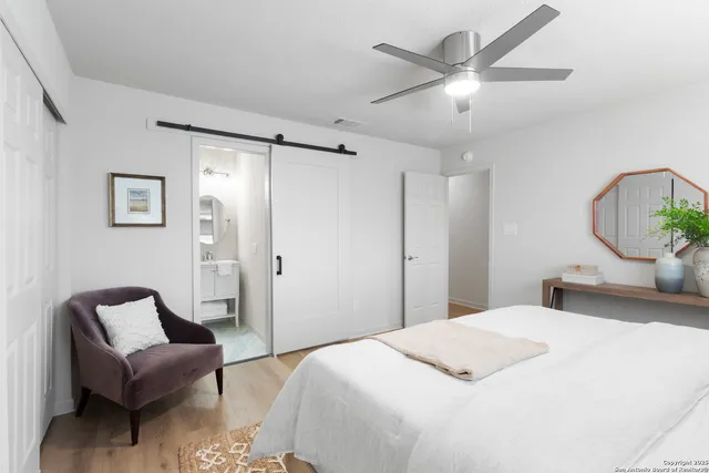 a bedroom with a bed couch and a window