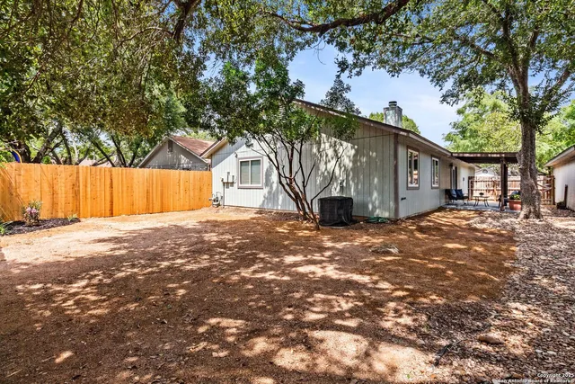 a view of a house with a tree back yard