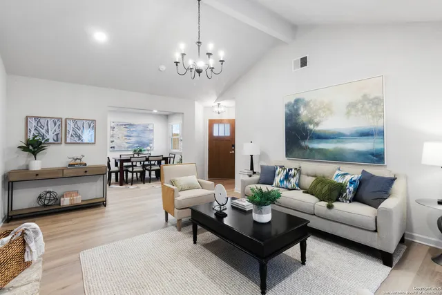 a living room with furniture and a chandelier