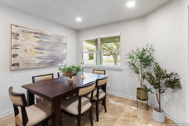 a view of a dining room with furniture and a potted plant