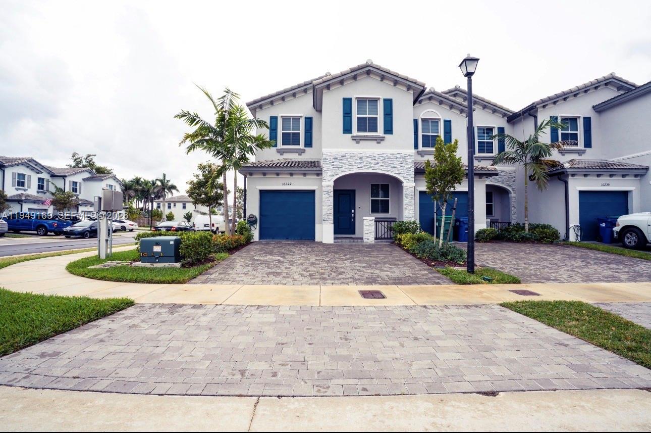 a front view of a house with a yard and garage