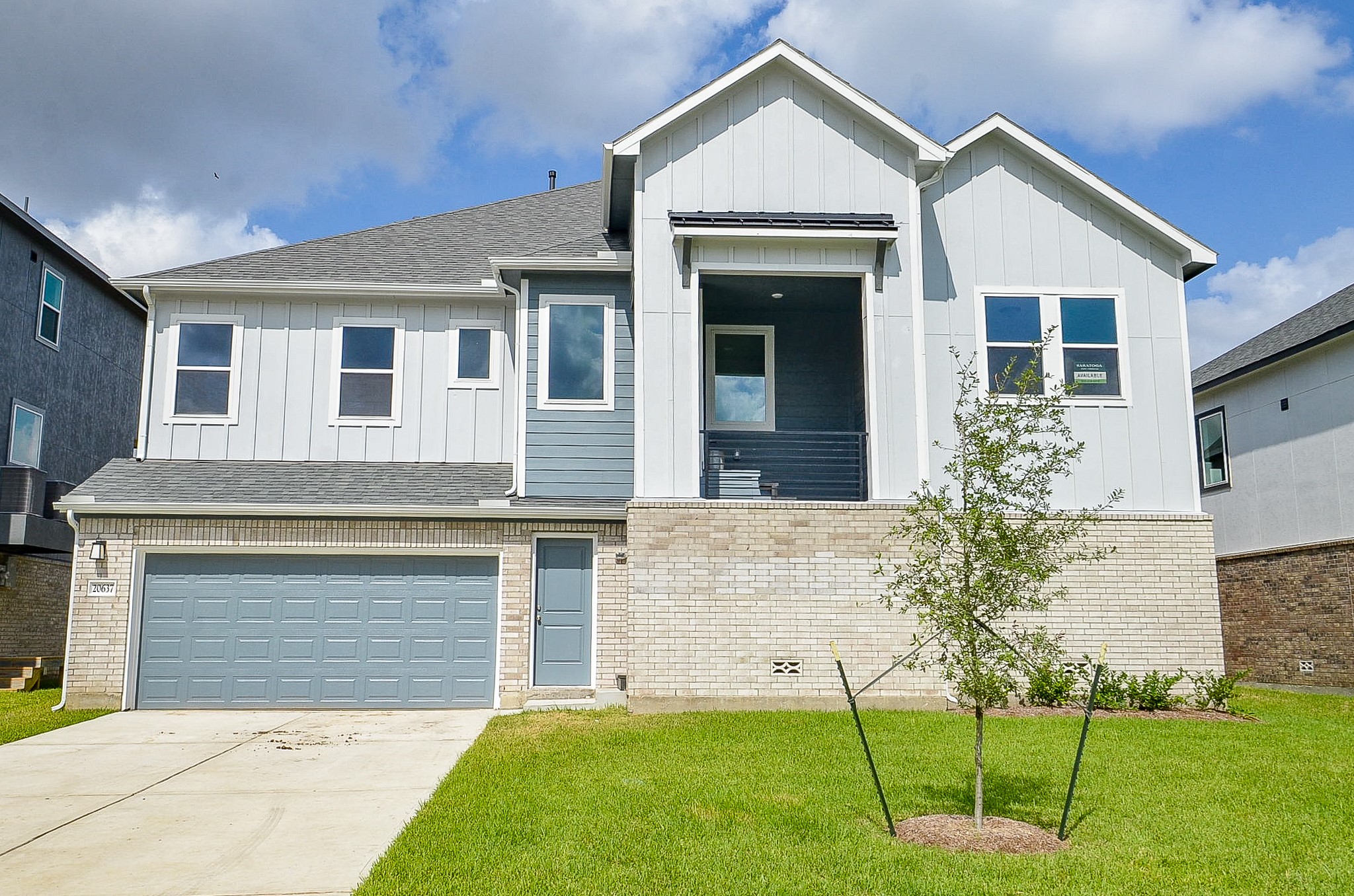 a front view of a house with a yard and fence