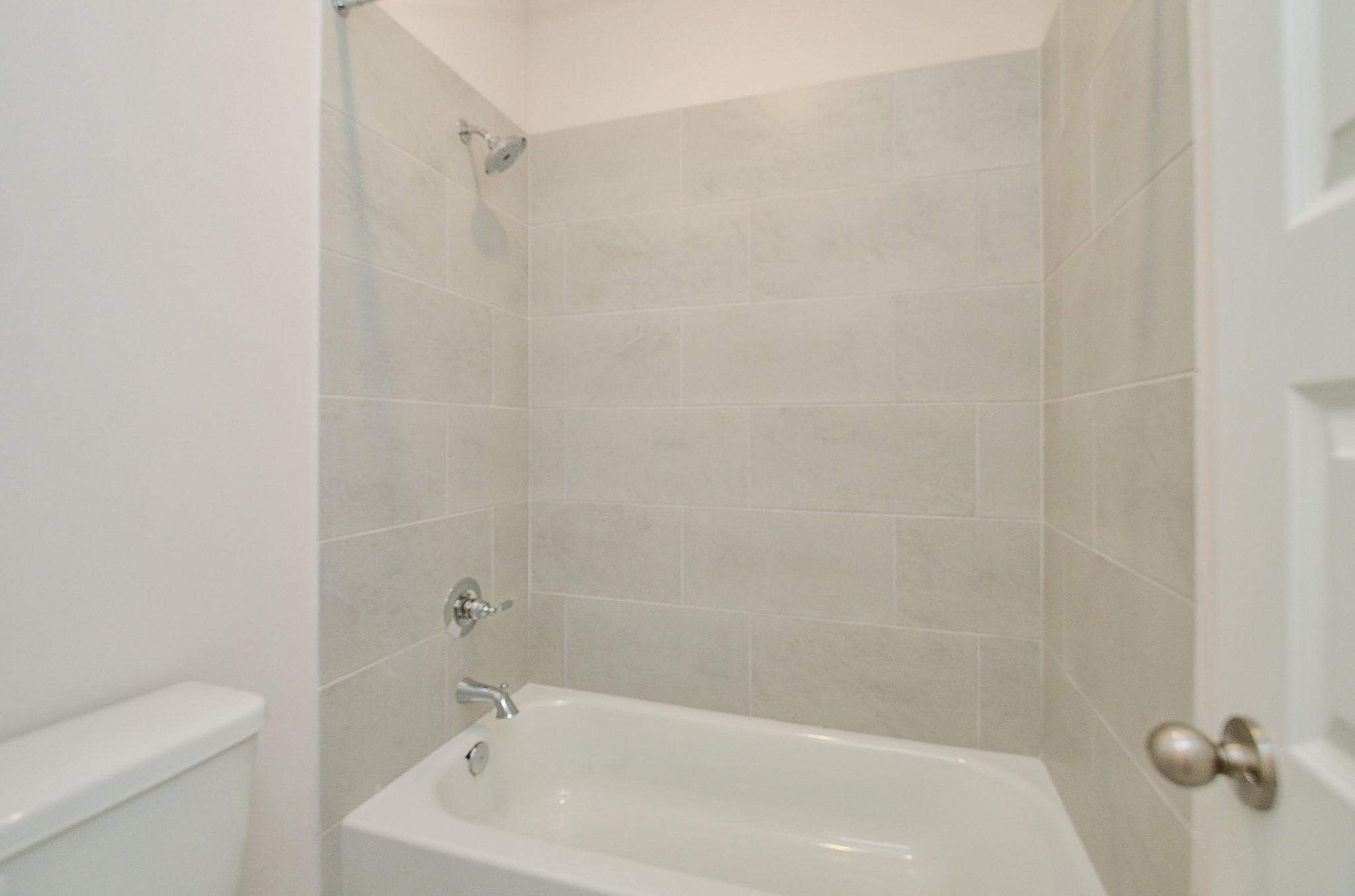 20637 Dynamic Court Humble, TX 77338 - Photo 23 of 32 a white bath tub sitting next to a white toilet and a shower