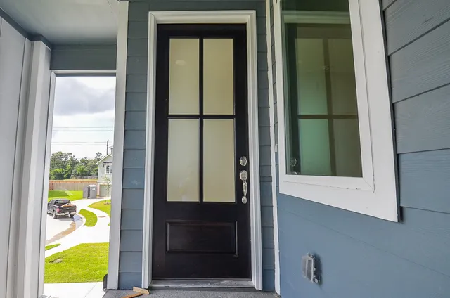 an entryway view with wooden floor and cabinet