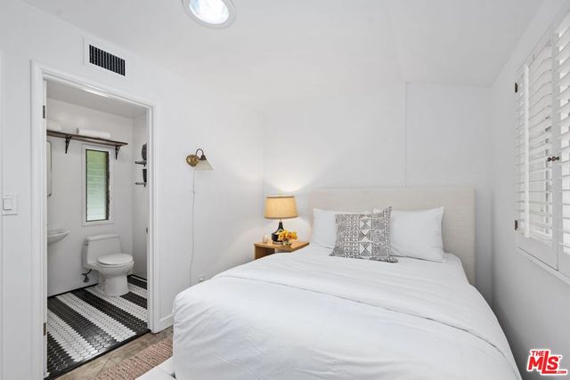 a bedroom with a bed and a lamp