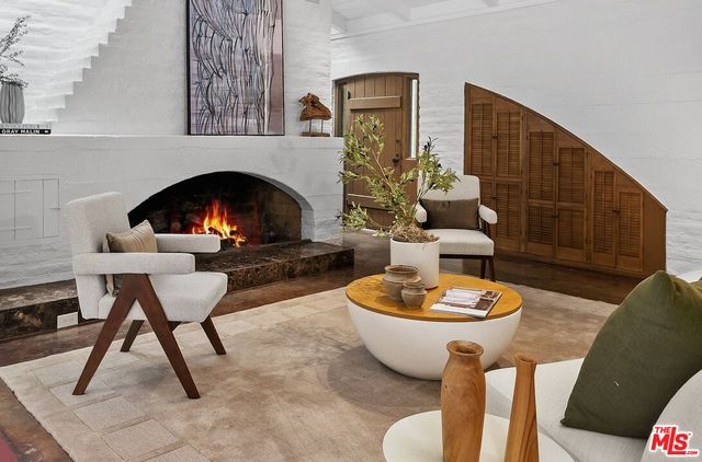 a living room with furniture a fireplace and a table