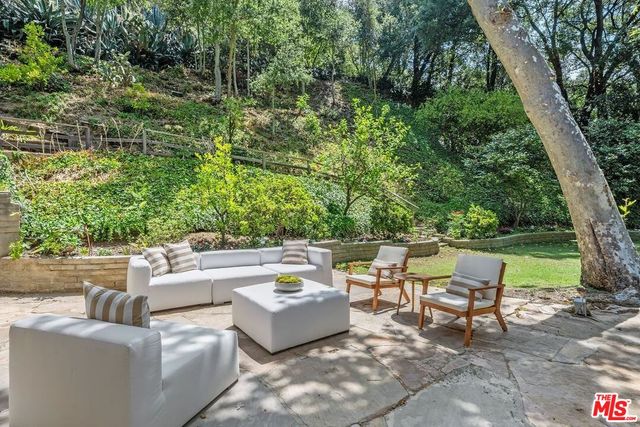 a backyard of a house with table and chairs