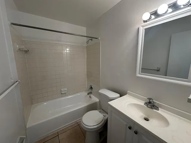 a bathroom with a sink mirror toilet and bathtub