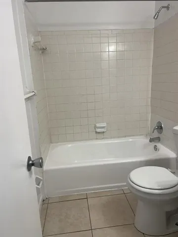 a bathroom with a toilet and a bath tub