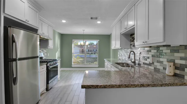 a kitchen with sink refrigerator and stove