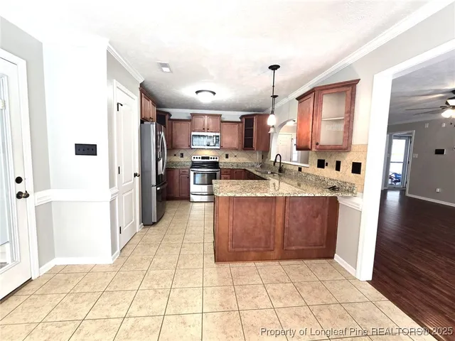 a kitchen with stainless steel appliances a refrigerator sink and cabinets