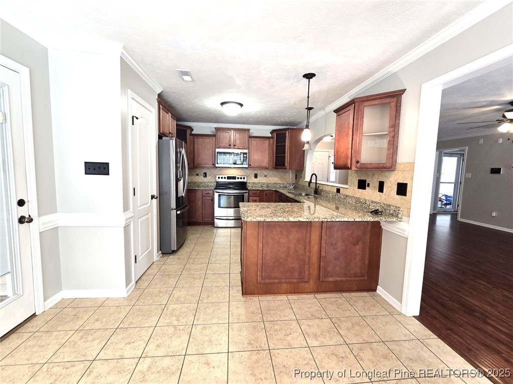 175 Briar Haven Court Raeford, NC 28376 - Photo 12 of 44 a kitchen with stainless steel appliances a refrigerator sink and cabinets