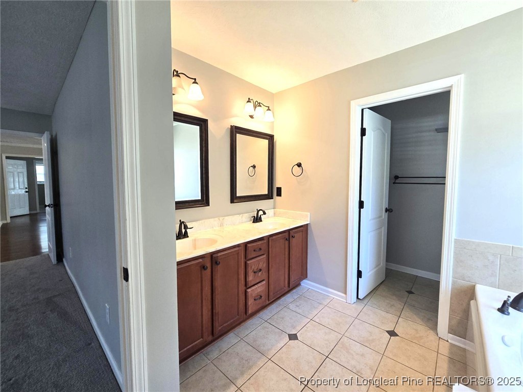 175 Briar Haven Court Raeford, NC 28376 - Photo 20 of 44 a spacious bathroom with a double vanity sink and a mirror