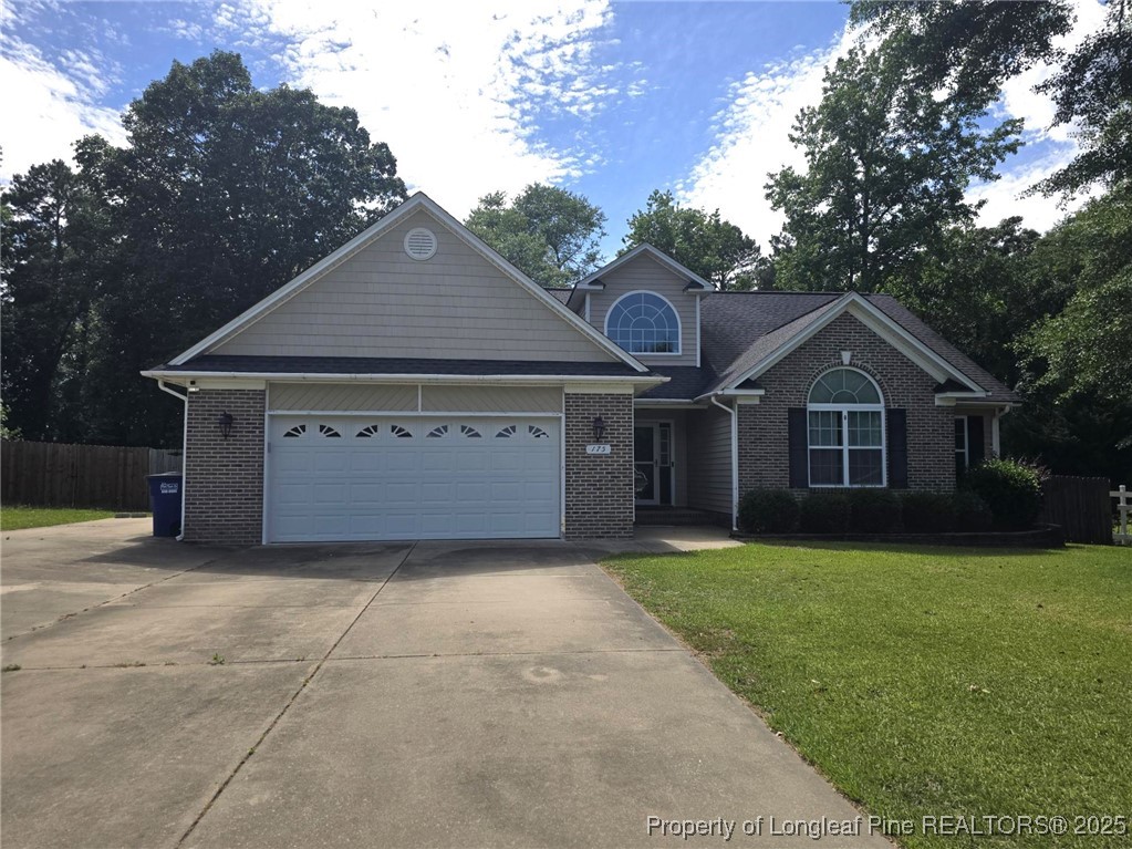 175 Briar Haven Court Raeford, NC 28376 - Photo 2 of 44 a front view of a house with a yard and garage
