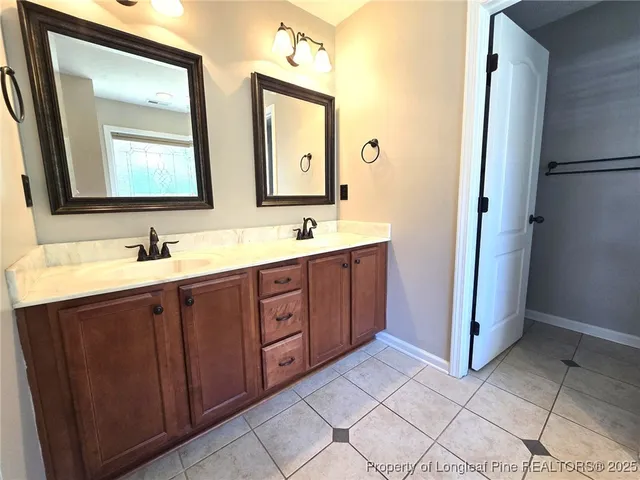 a bathroom with a double vanity sink and mirror