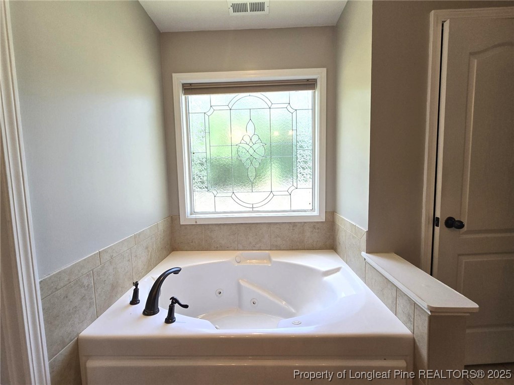 175 Briar Haven Court Raeford, NC 28376 - Photo 22 of 44 a bath tub sitting in a bathroom next to a window