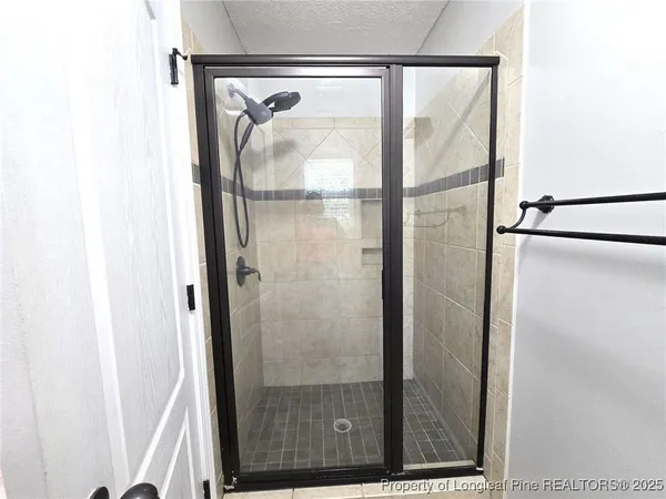 a bathroom with a glass shower door