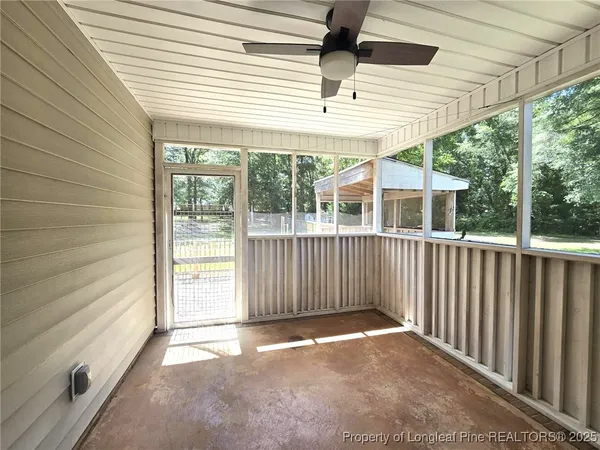 a view of a swimming pool with a patio and a yard