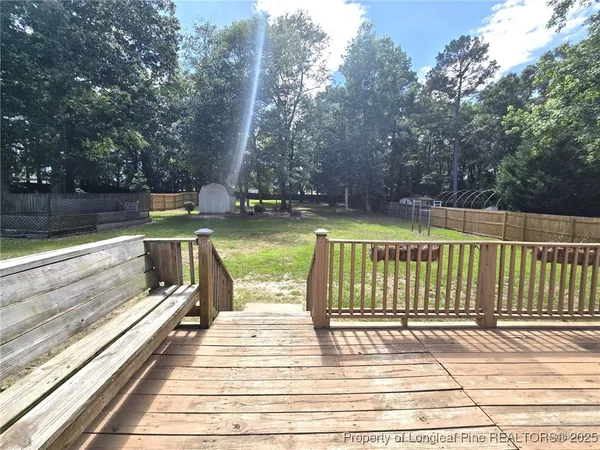 a view of balcony with wooden floor and fence