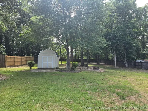 a view of a yard with a tree