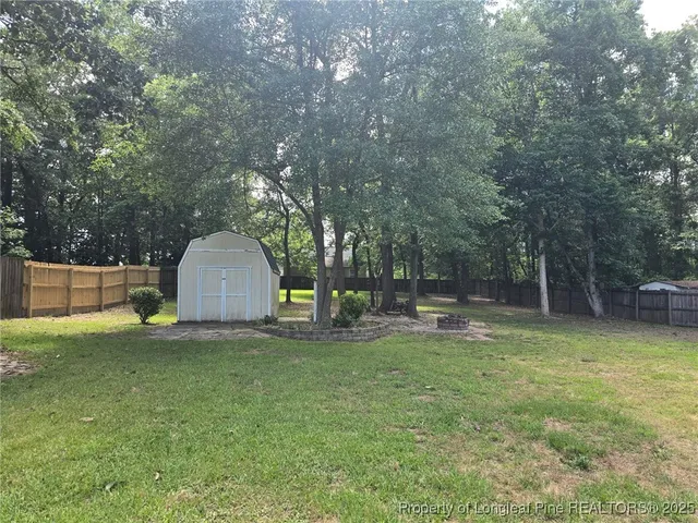 a view of a yard with a tree