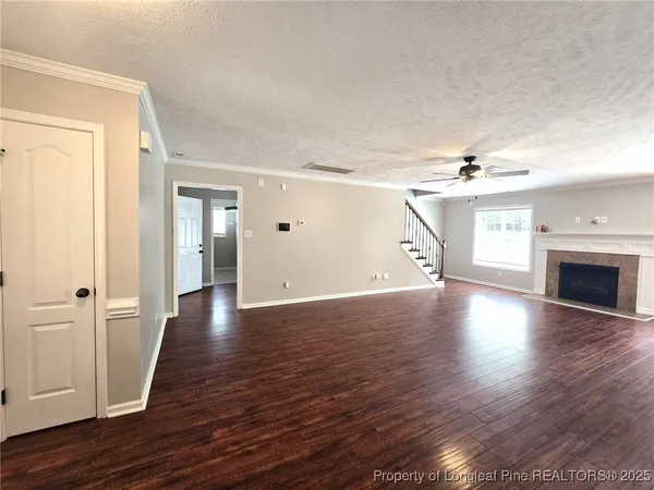 wooden floor in an empty room with a fireplace
