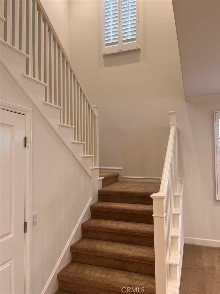 119 Alumroot Irvine, CA 92620 - Photo 11 of 35 a view of staircase with wooden floor and white walls