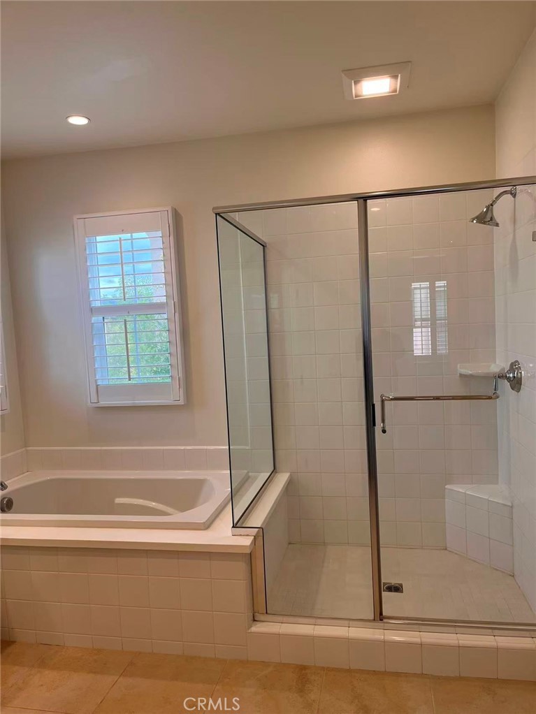 119 Alumroot Irvine, CA 92620 - Photo 16 of 35 a bathroom with a bathtub and a shower