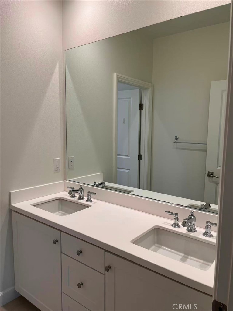 119 Alumroot Irvine, CA 92620 - Photo 21 of 35 a bathroom with a sink and a mirror