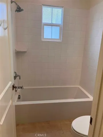 a bathroom with a bathtub and toilet