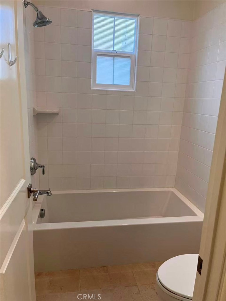 119 Alumroot Irvine, CA 92620 - Photo 22 of 35 a bathroom with a bathtub and toilet
