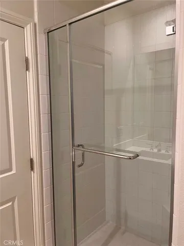 a bathroom with a glass shower door
