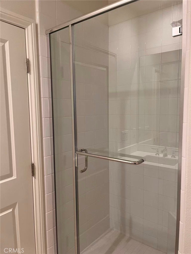 119 Alumroot Irvine, CA 92620 - Photo 27 of 35 a bathroom with a glass shower door