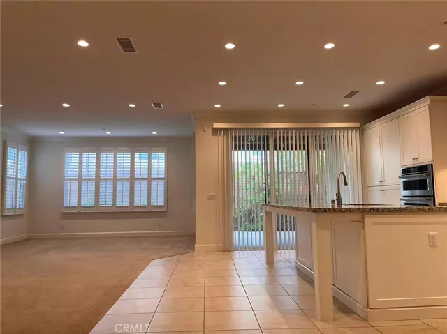 a view of a kitchen with granite countertop stainless steel appliances lots of counter top space