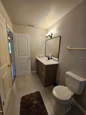 a bathroom with a sink toilet and mirror