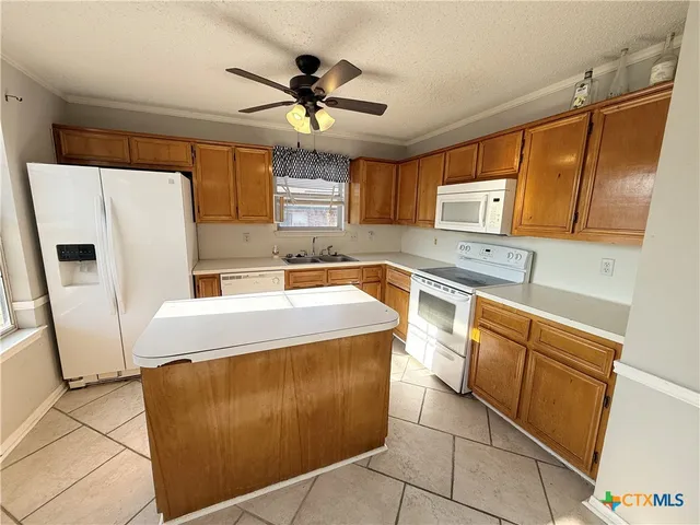 a kitchen with a refrigerator a sink and cabinets
