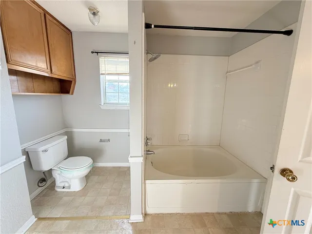 a bathroom with a shower and a toilet