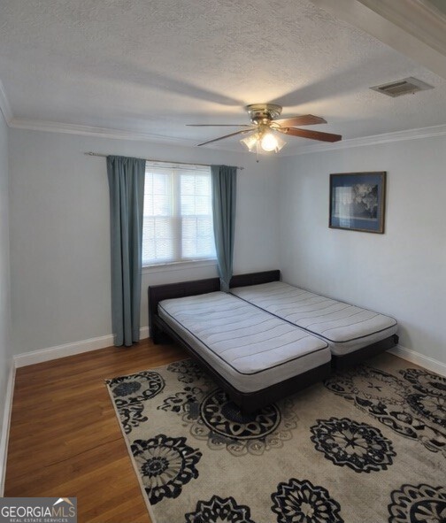 13 Marshall Street Butler, GA 31006 - Photo 12 of 27 a bedroom with a bed and wooden floor