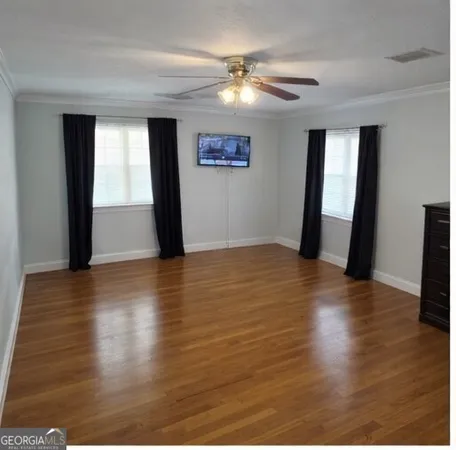 a bedroom with furniture and wooden floor