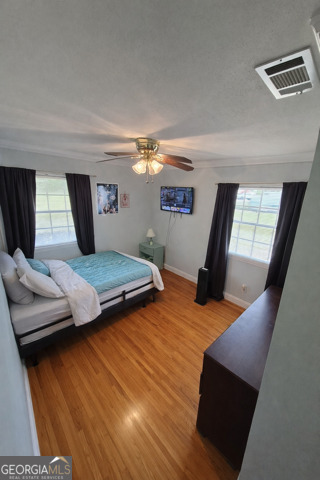 13 Marshall Street Butler, GA 31006 - Photo 14 of 27 a bedroom with furniture and wooden floor